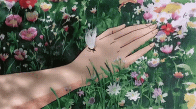 A Person Is Holding A Butterfly On Their Hand . GIF