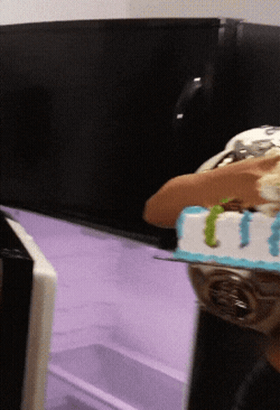 A Person Is Holding A Cake That Says I Love You On It GIF