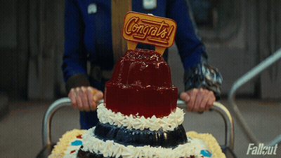A Person Is Holding A Cake With A Congratulations Sign On Top GIF