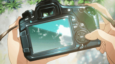 A Person Is Holding A Camera With The Off And On Buttons On The Back GIF