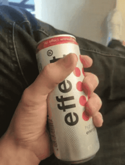 A Person Is Holding A Can Of Effervescent Energy Drink In Their Hand GIF