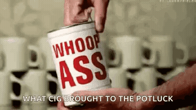A Person Is Holding A Can Of Whoop Ass Coffee . GIF