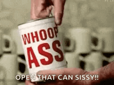 A Person Is Holding A Can Of Whoop Ass . GIF