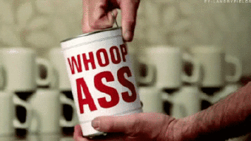 A Person Is Holding A Can Of Whoop Ass GIF