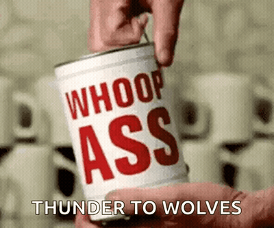 A Person Is Holding A Can Of Whoop Ass Thunder To Wolves . GIF