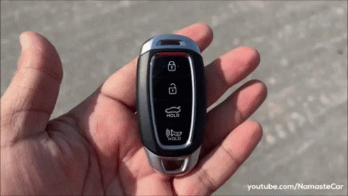 A Person Is Holding A Car Key That Says Hold GIF
