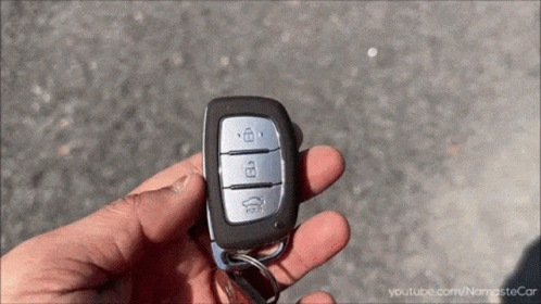 A Person Is Holding A Car Key With Youtube.com/namastecar Written Below It GIF