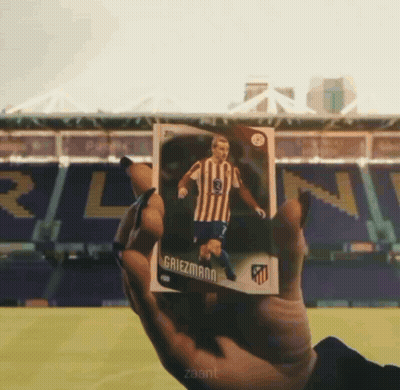 A Person Is Holding A Card That Says Griezmann On It GIF