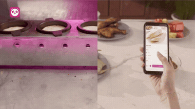 A Person Is Holding A Cell Phone In Front Of A Stove And A Plate Of Food GIF