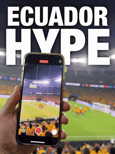 A Person Is Holding A Cell Phone In Front Of An Ecuador Hype Poster GIF
