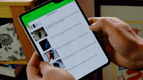 A Person Is Holding A Cell Phone With A Green Screen That Says ' Androidcentral ' On It GIF