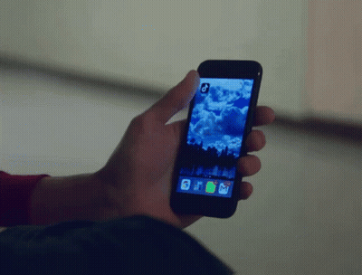 A Person Is Holding A Cell Phone With A Picture Of A Cloudy Sky On The Screen GIF