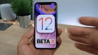 A Person Is Holding A Cell Phone With Beta X On The Screen GIF