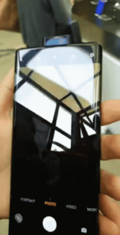 A Person Is Holding A Cell Phone With The Portrait Photo Video And More Buttons On It GIF