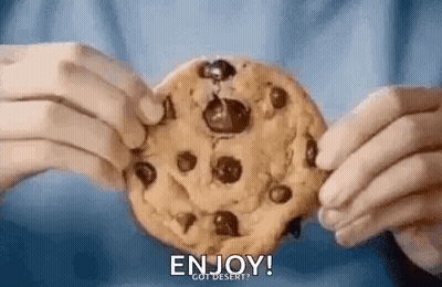A Person Is Holding A Chocolate Chip Cookie In Their Hands And Saying `` Enjoy ! `` GIF