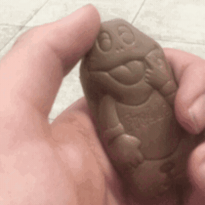 A Person Is Holding A Chocolate Turtle In Their Hand GIF