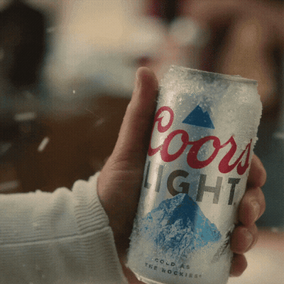 A Person Is Holding A Coors Light Can In Their Hand GIF