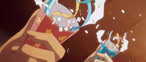 A Person Is Holding A Cup With A Star On It And Confetti Coming Out Of It GIF