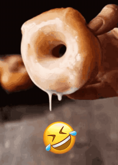 A Person Is Holding A Donut With Icing Dripping Out Of It GIF