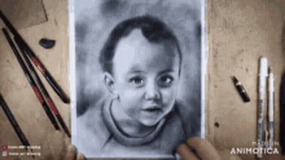 A Person Is Holding A Drawing Of A Child 'S Face GIF