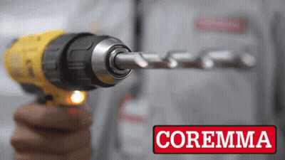 A Person Is Holding A Drill With The Word Coremma On The Bottom Right GIF