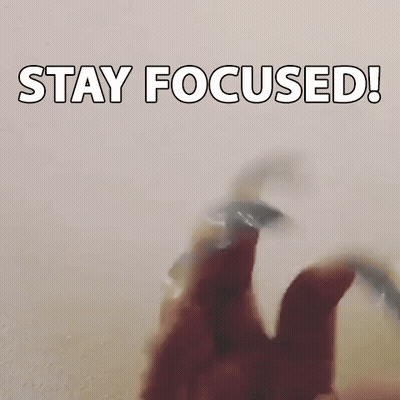A Person Is Holding A Fidget Spinner In Their Hand With The Words `` Stay Focused '' Written On It . GIF