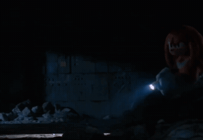 A Person Is Holding A Flashlight In A Dark Room GIF