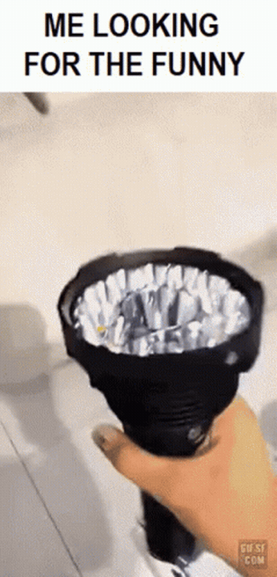 A Person Is Holding A Flashlight In Their Hand With The Caption Me Looking For The Funny . GIF