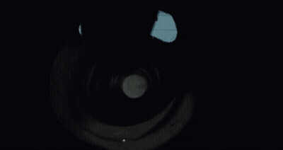 A Person Is Holding A Flashlight Inside Of A Tunnel GIF