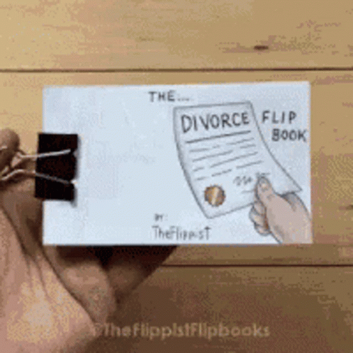 A Person Is Holding A Flip Book That Says Divorce GIF