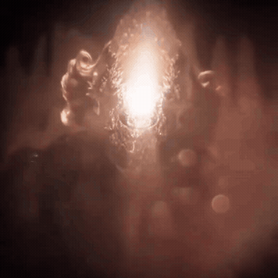 A Person Is Holding A Glowing Object In Their Hands In The Dark . GIF