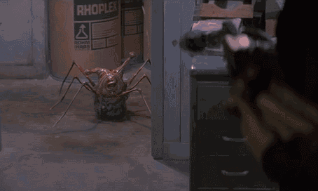 A Person Is Holding A Gun In Front Of A Container That Says Rhopedia On It GIF