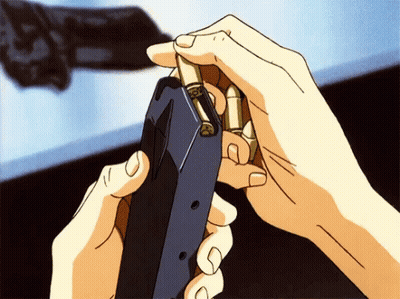 A Person Is Holding A Gun With Bullets In Their Hands GIF