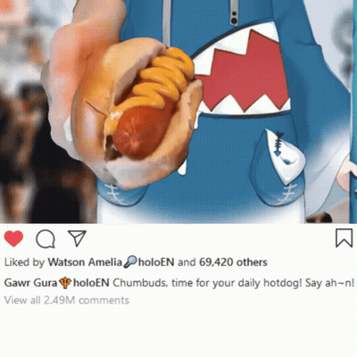 A Person Is Holding A Hot Dog With Cheese And A Picture Of A Shark Behind It GIF