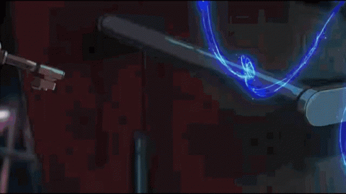 A Person Is Holding A Key That Is Surrounded By Blue Swirls GIF