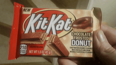 A Person Is Holding A Kit Kat Chocolate Frosted Donut Bar GIF