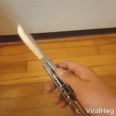 A Person Is Holding A Knife With The Word Viralhog On The Bottom Left GIF