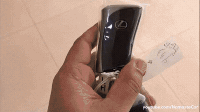 A Person Is Holding A Lexus Key Fob In A Plastic Bag GIF