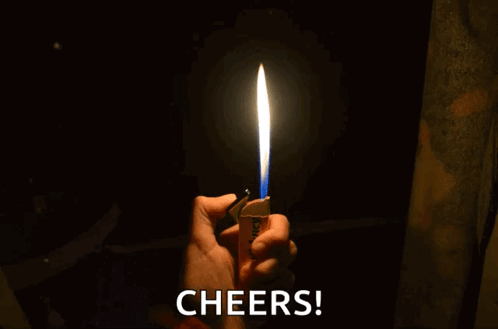 A Person Is Holding A Lighter With A Blue Flame And The Words Cheers Behind Them GIF