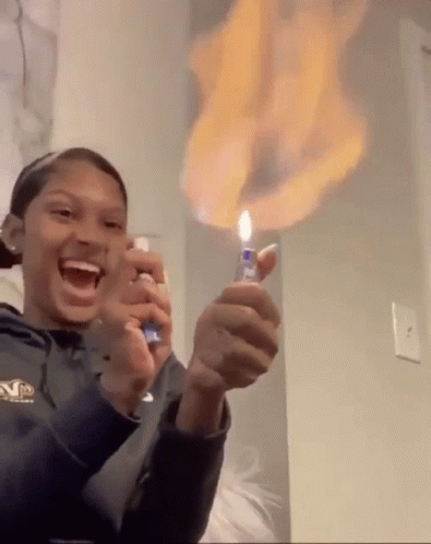 A Person Is Holding A Lighter With Flames Coming Out Of It GIF