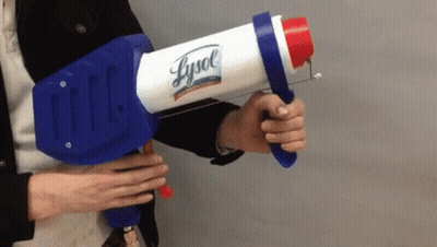 A Person Is Holding A Lysol Spray Gun GIF