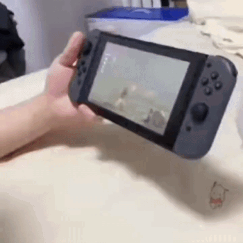 A Person Is Holding A Nintendo Switch In Their Hand And Playing A Video Game . GIF