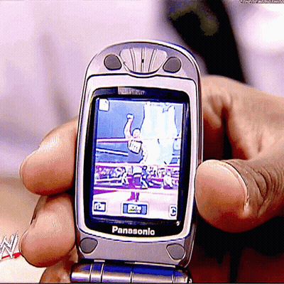 A Person Is Holding A Panasonic Flip Phone In Their Hands GIF