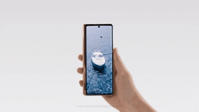 A Person Is Holding A Phone That Has A Boat On The Screen GIF