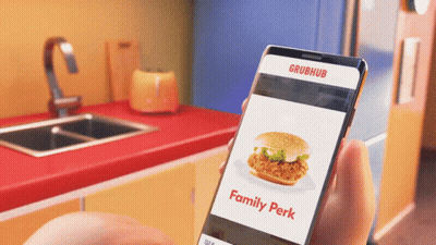 A Person Is Holding A Phone That Says Grubhub On The Screen GIF