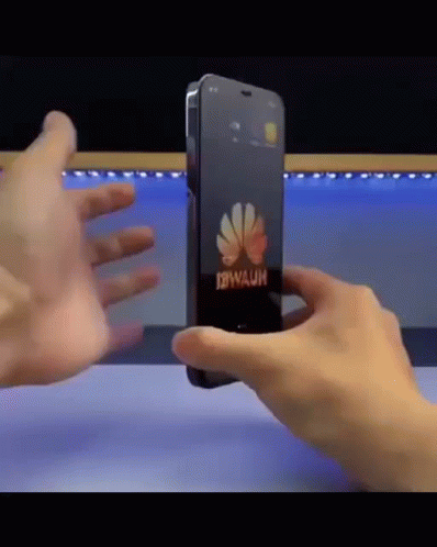 A Person Is Holding A Phone That Says Huawei On It GIF