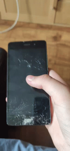 A Person Is Holding A Phone With A Broken Screen GIF
