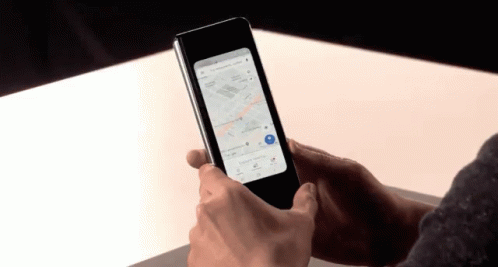 A Person Is Holding A Phone With A Map On It GIF