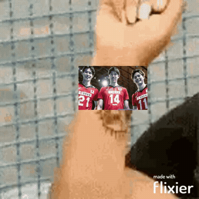 A Person Is Holding A Picture Of Three Volleyball Players With The Number 14 On Their Jersey GIF