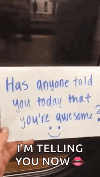 A Person Is Holding A Piece Of Paper That Says `` Has Anyone Told You Today That You 'Re Awesome ? `` GIF